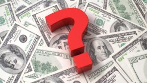 Dollar bills with a question mark in the middle